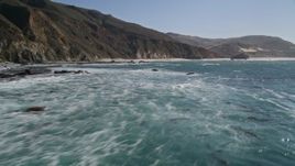 5K aerial video of flying over the ocean, tilt up to reveal coastal cliffs, Big Sur, California Aerial Stock Footage | AXSF16_076