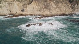 5K aerial stock footage of passing ocean rock formations near coastal cliffs, Big Sur, California Aerial Stock Footage | AXSF16_081