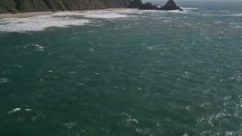 5K aerial stock footage of tilting up from the ocean to reveal coastal cliffs and rock formations, Big Sur, California Aerial Stock Footage | AXSF16_098