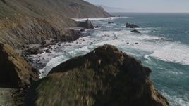 5K aerial stock footage tilt from the ocean to reveal coastal rock formations and cliffs, Big Sur, California Aerial Stock Footage | AXSF16_099