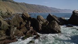 5K aerial stock footage tilt from ocean to reveal rock formation near coastal cliffs, Big Sur, California Aerial Stock Footage | AXSF16_103