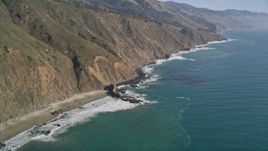 5K aerial stock footage of panning across coastal cliffs and a beach, Big Sur, California Aerial Stock Footage | AXSF16_106