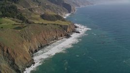 5K aerial stock footage of tilting from ocean kelp to reveal coastal cliffs, Big Sur, California Aerial Stock Footage | AXSF16_108
