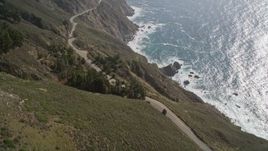 5K aerial stock footage fly over Highway 1 winding atop cliffs, tilt to reveal ocean views, Big Sur, California Aerial Stock Footage | AXSF16_114