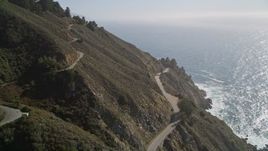 5K aerial stock footage tilt from Highway 1 atop coastal cliffs to wider ocean view, Big Sur, California Aerial Stock Footage | AXSF16_115