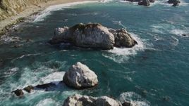 5K aerial stock footage of flying over large coastal rock formations in the ocean, Big Sur, California Aerial Stock Footage | AXSF16_119