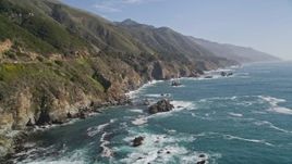 5K aerial stock footage of tilting from the ocean to reveal coastal cliffs, Big Sur, California Aerial Stock Footage | AXSF16_123
