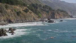 5K aerial stock footage of flying low by steep coastal cliffs and rock formations, Big Sur, California Aerial Stock Footage | AXSF16_126