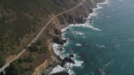 5K aerial stock footage of flying by a small bridge and Highway 1 atop coastal cliffs, Big Sur, California Aerial Stock Footage | AXSF16_130