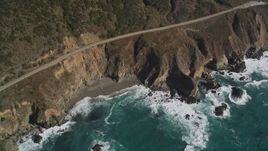 5K aerial stock footage tilt Highway 1 coastal road, small beach and coastal cliffs, Big Sur, California Aerial Stock Footage | AXSF16_131