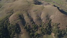 5K aerial stock footage of a reverse view of following green hills in San Luis Obispo County, California Aerial Stock Footage | AXSF16_145