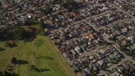 5K aerial stock footage of a reverse view of suburban homes, reveal Morro Bay Golf Course, California Aerial Stock Footage | AXSF16_154