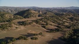 5K aerial stock footage of approaching hills and scattered trees in San Luis Obispo County, California Aerial Stock Footage | AXSF17_011