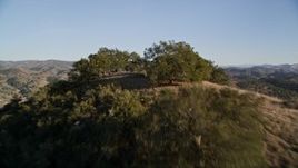 5K aerial stock footage flying over trees on a hilltop, San Luis Obispo County, California Aerial Stock Footage | AXSF17_013