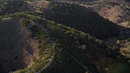 5K aerial stock footage of a reverse view if hills with green trees in San Luis Obispo County, California Aerial Stock Footage | AXSF17_014