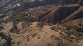 5K aerial stock footage of flying away from country roads in the hills, San Luis Obispo County, California Aerial Stock Footage | AXSF17_016