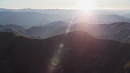 5K aerial stock footage tilt from shadowy slopes to hazy mountains, San Luis Obispo County, California Aerial Stock Footage | AXSF17_023