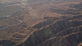 5K aerial stock footage of flying by a dry riverbed and Caliente Range mountains, Cuyama Valley, California Aerial Stock Footage | AXSF17_031