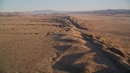 5K aerial stock footage fly over San Andreas Fault, tilt for a view of desert valley, distant mountains, San Luis Obispo County, California Aerial Stock Footage | AXSF17_042
