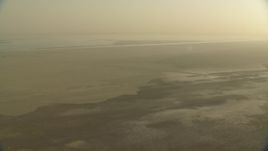 HD stock footage aerial video of flying over a hazy desert at sunrise in Al Selmiyyah, Abu Dhabi, UAE Aerial Stock Footage | CAP_001_002