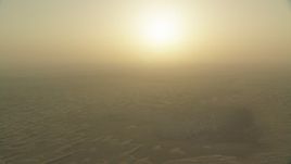 HD stock footage aerial video of the sunrise above sand dunes, Al Selmiyyah, Abu Dhabi, UAE Aerial Stock Footage | CAP_001_003