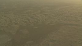 HD stock footage aerial video of sand dunes during a hazy sunrise in Al Gharbia, Abu Dhabi, UAE Aerial Stock Footage | CAP_001_008