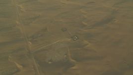 HD stock footage aerial video of orbiting buildings and sand dunes at sunrise, Al Gharbia, Abu Dhabi, UAE Aerial Stock Footage | CAP_001_011