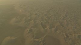 HD stock footage aerial video of orbit and fly away from desert sand dunes at sunrise in Al Gharbia, Abu Dhabi, UAE Aerial Stock Footage | CAP_001_012