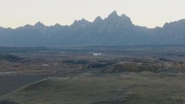 HD stock footage aerial video fly over hills toward rugged mountains, Jackson Hole, Wyoming, twilight Aerial Stock Footage | CAP_002_002