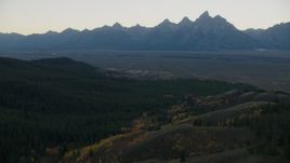 HD stock footage aerial video of mountains seen from evergreen forest, Jackson Hole, Wyoming, twilight Aerial Stock Footage | CAP_002_009