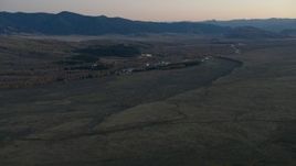 HD stock footage aerial video of autumn trees, hills and a river in Jackson Hole, Wyoming, twilight Aerial Stock Footage | CAP_002_020