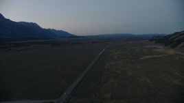 HD stock footage aerial video of flying by Highway 26, Jackson Hole, Wyoming, twilight Aerial Stock Footage | CAP_002_022