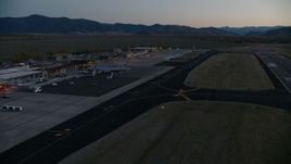 HD stock footage aerial video pan to terminals and hangers at Jackson Hole Airport, Wyoming, twilight Aerial Stock Footage | CAP_002_025