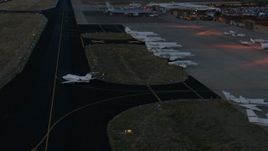 HD stock footage aerial video of a jet taxiing onto the runway at Jackson Hole Airport, Wyoming, twilight Aerial Stock Footage | CAP_002_026