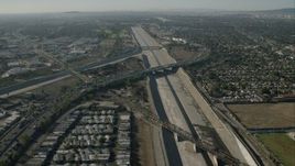 HD stock footage aerial video follow LA River over freeways in South Gate, California Aerial Stock Footage | CAP_003_001