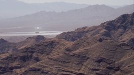 HD stock footage aerial video of zoom tighter on one of the solar towers, Ivanpah Solar Electric Generating System, Mojave Desert, California Aerial Stock Footage | CAP_005_014