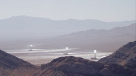 HD stock footage aerial video of solar towers at Ivanpah Solar Electric Generating System seen from mountains, Mojave Desert, California Aerial Stock Footage | CAP_005_016