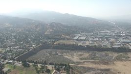 HD stock footage aerial video of warehouse buildings and a large landfill area in Sun Valley, California Aerial Stock Footage | CAP_006_003