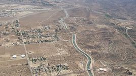 HD stock footage aerial video pass rural homes and desert around the California Aqueduct in Palmdale, California Aerial Stock Footage | CAP_006_007
