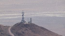 HD stock footage aerial video of mountaintop radio towers in the Mojave Desert, San Bernardino County, California Aerial Stock Footage | CAP_006_014