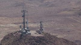 HD stock footage aerial video of radio towers on a Mojave Desert mountain summit in San Bernardino County, California Aerial Stock Footage | CAP_006_015