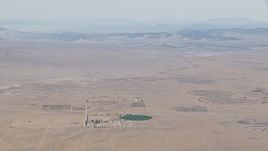 HD stock footage aerial video approach a crop field and a Mojave Desert monastery in Newberry Springs, California Aerial Stock Footage | CAP_006_020
