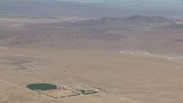 HD stock footage aerial video zoom to a wiper view of a lonely Mojave Desert monastery and crop circle in Newberry Springs, California Aerial Stock Footage | CAP_006_027