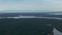 HD stock footage aerial video of a view of the Olympic Mountain range, seen from Anderson Island in Puget Sound, Washington Aerial Stock Footage | CAP_009_003