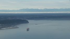 HD stock footage aerial video of a cargo ship sailing Puget Sound and the Olympic Mountains, Washington Aerial Stock Footage | CAP_009_019