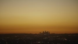 HD stock footage aerial video bright light over the Downtown Los Angeles city skyline at twilight, California Aerial Stock Footage | CAP_010_007