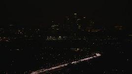 HD stock footage aerial video approach the Downtown Los Angeles city skyline at night, California Aerial Stock Footage | CAP_010_010