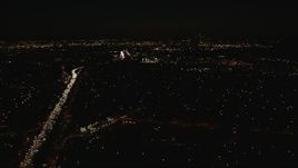 HD stock footage aerial video tilt from freeway gridlock to the Downtown Los Angeles city skyline at night, California Aerial Stock Footage | CAP_010_011