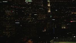 HD stock footage aerial video tilt from Downtown Los Angeles city buildings to Figueroa and Wilshire skyscraper at night, California Aerial Stock Footage | CAP_010_014