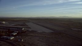 HD stock footage aerial video approach and pan across the Barstow-Daggett Airport in California at sunrise Aerial Stock Footage | CAP_011_006